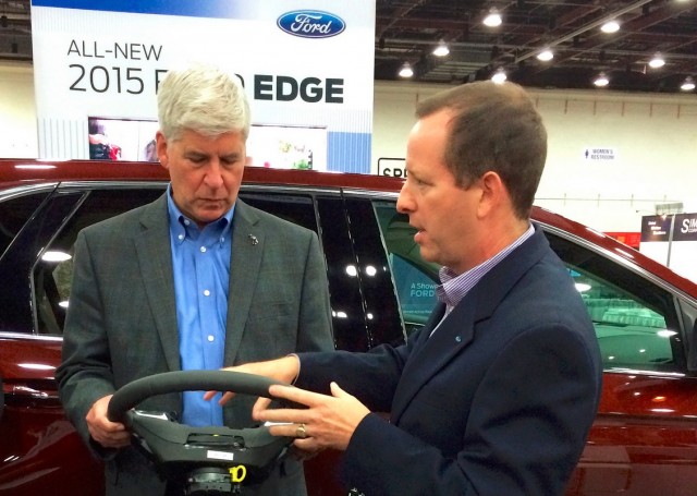 Michigan Governor Rick Snyder with Ford's steering wheel technology at ITS World Congress, Detroit