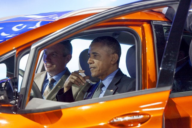President Barack Obama sits in 2017 Chevrolet Bolt EV electric car at Detroit Auto Show, Jan 2016