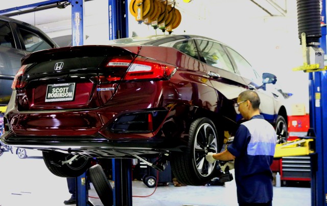 Service technician working on Honda Clarity Fuel Cell at dealership