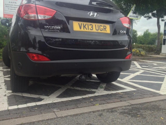 Hyundai ix35 (Tucson) gasoline car parked in electric-car charging spot, Oxford Services, U.K.