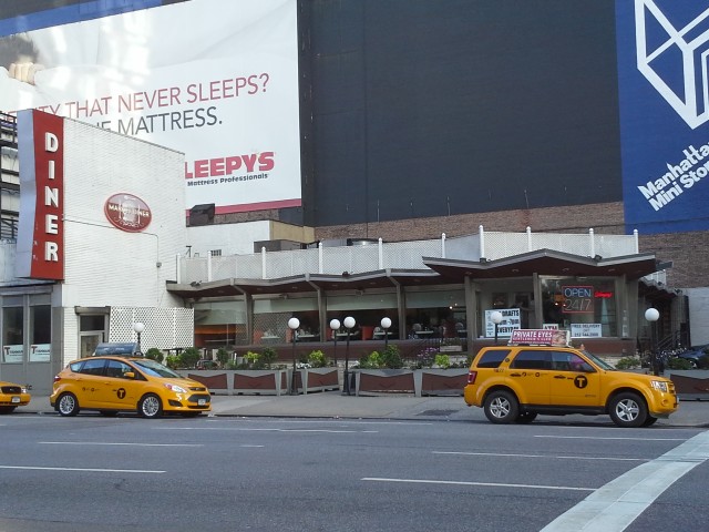 Three Ford taxi cabs in New York City: Crown Victoria, C-Max Hybrid, and Escape Hybrid