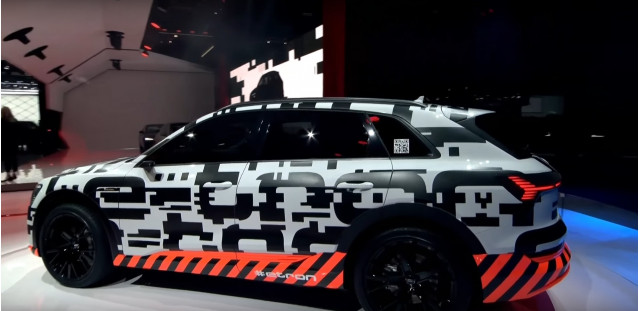 Camouflaged 2019 Audi e-tron electric SUV on stage at 2018 Geneva auto show