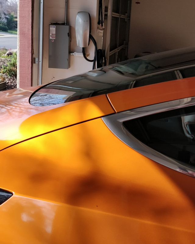 George Parrot's Tesla Wall Charger in his garage with his Tesla Model 3 [Credit: George Parrot]