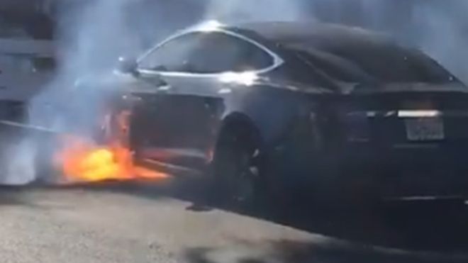 Director Michael Morris's Tesla Model S on fire [PHOTO CREDIT - MARY MCCORMICK]