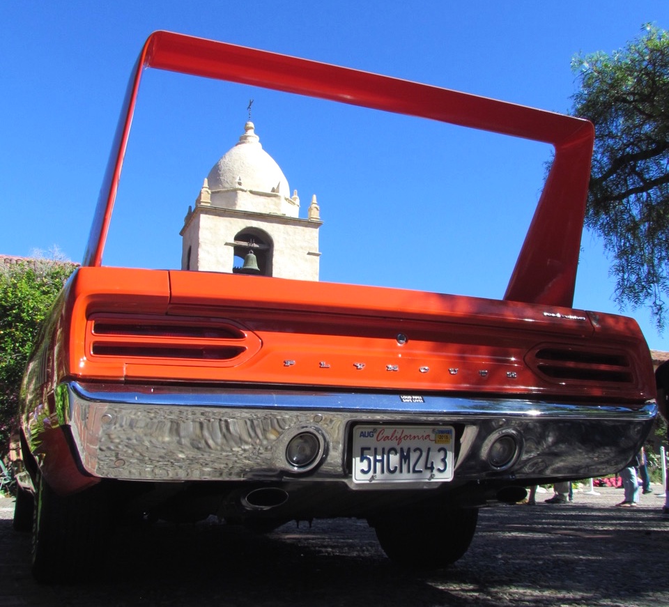 Rear wing of a 1970 Plymouth Road Runner frames the mission bell tower | Larry Edsall photo
