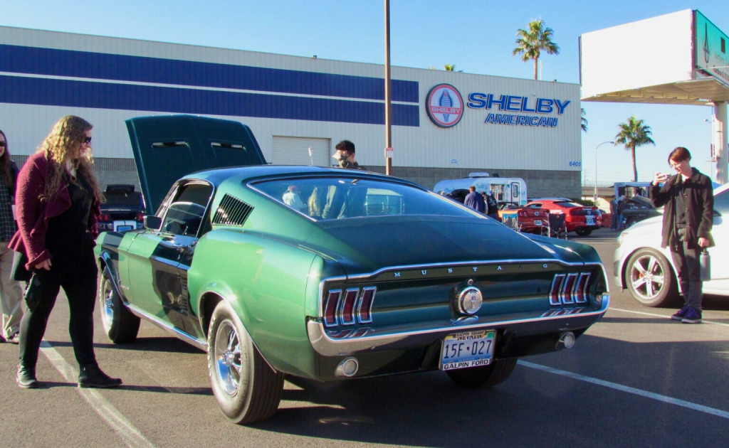 A vintage Mustang in Bullitt-green color draws attention at the Cars and Coffee Las Vegas event in t
