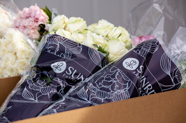 A local florist donated hundreds of flowers for delivery to Meals on Wheels clients.