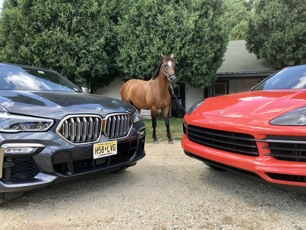 2020 BMW X6 M50i, left, and 2020 Porsche Cayenne Coupe S, right