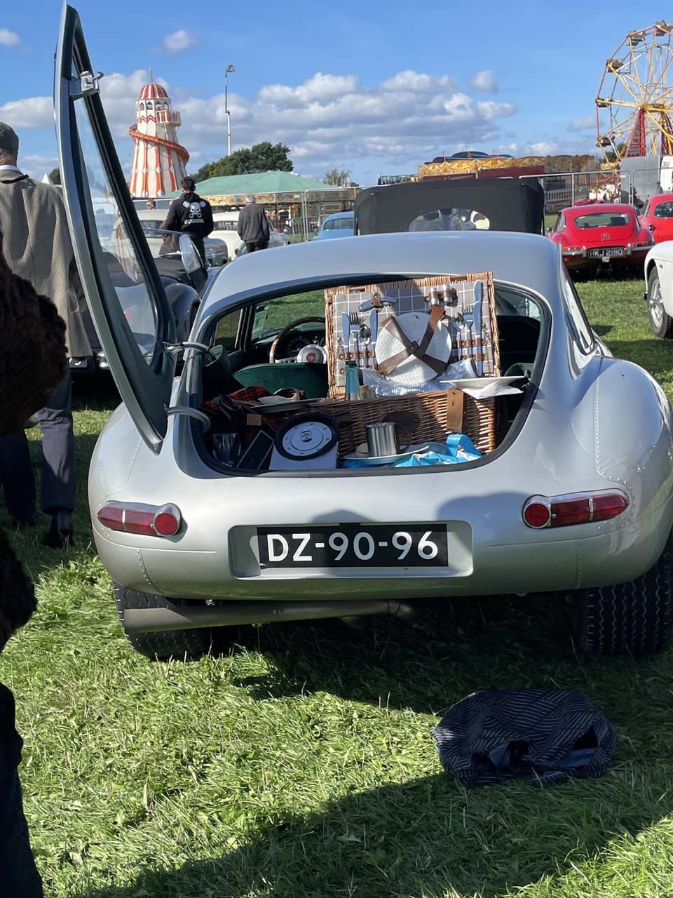 A picnic out of the back of a Jaguar E-Type in the 2022 Goodwood Revival parking lot A picnic out of the back of a Jaguar E-Type in the 2022 Goodwood Revival parking lot