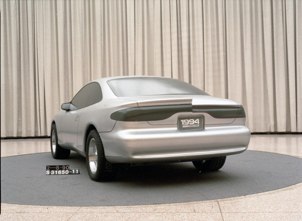 Full-width taillamps were made popular with the first-generation Taurus and Sable, so it made sense to try them out with the Mustang. This didn’t pan out. The sloping rear deck on the right side of this two-sided clay model for the 1994 Mustang is similar to the Thunderbird of the same period (Image courtesy of Ford Motor Company) Full-width taillamps were made popular with the first-generation Taurus and Sable, so it made sense to try them out with the Mustang. This didn’t pan out. The sloping rear deck on the right side of this two-sided clay model for the 1994 Mustang is similar to the Thunderbird of the same period (Image courtesy of Ford Motor Company)