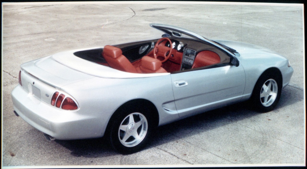 This convertible version of a 1994 Mustang theme had a hard cover over the folded top and a bold red interior. You can also see the dual cockpit intake was very far along in development at this point. This is one of the first concepts to feature tri-bar taillamps, in this case in the traditional vertical arrangement (Image courtesy of Ford Motor Company) This convertible version of a 1994 Mustang theme had a hard cover over the folded top and a bold red interior. You can also see the dual cockpit intake was very far along in development at this point. This is one of the first concepts to feature tri-bar taillamps, in this case in the traditional vertical arrangement (Image courtesy of Ford Motor Company)